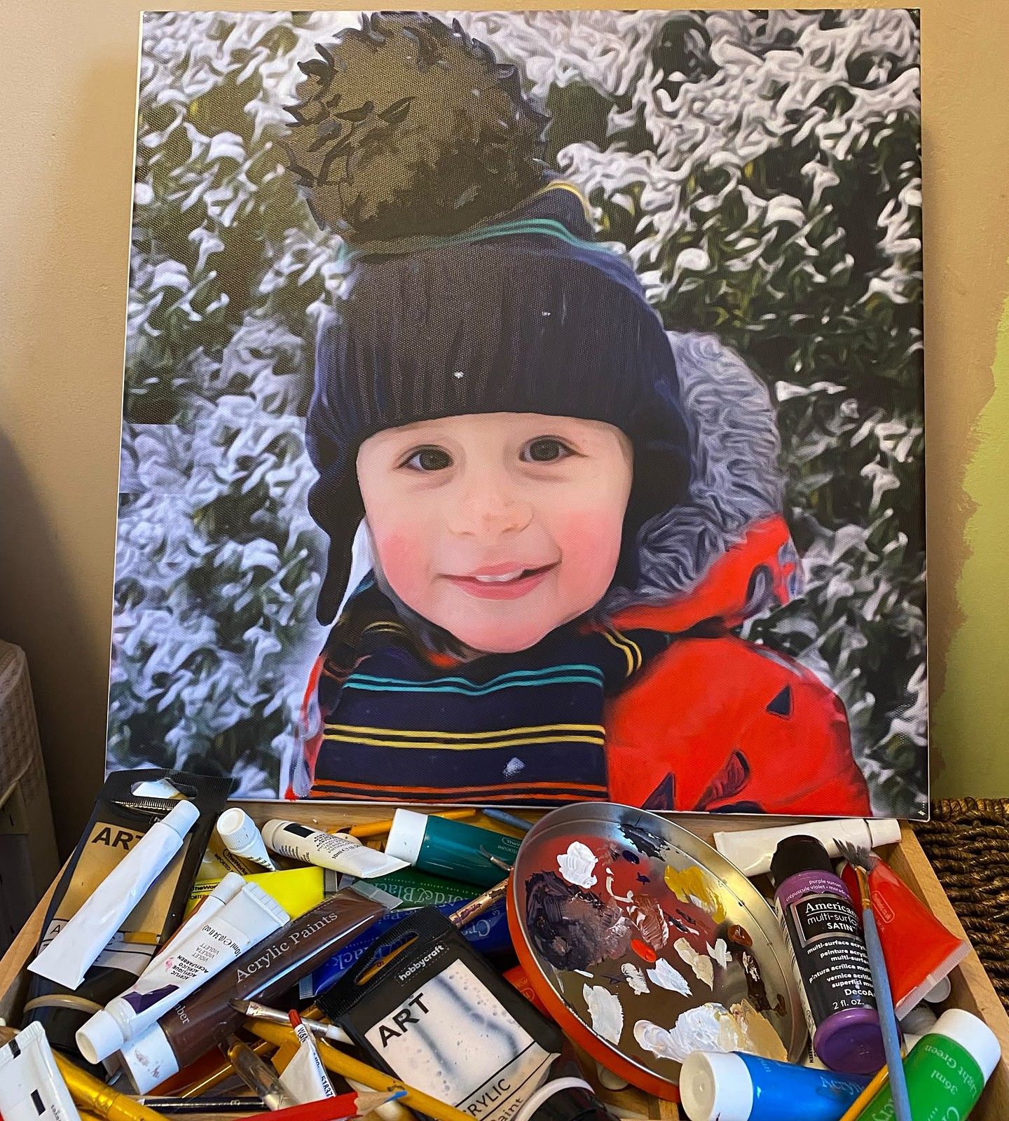Portrait of a smiling little boy in a winter hat in the snow