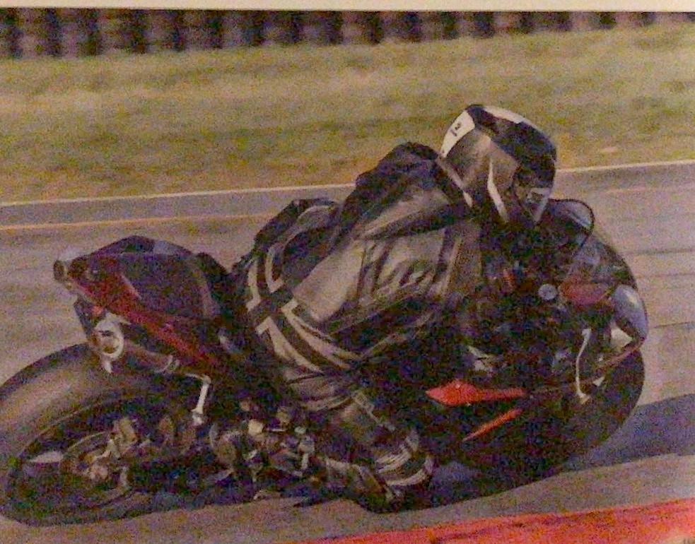 Painting of a motorcycle racer leaning into a corner